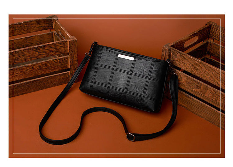 Clutched splicing soft leather crossbody bag